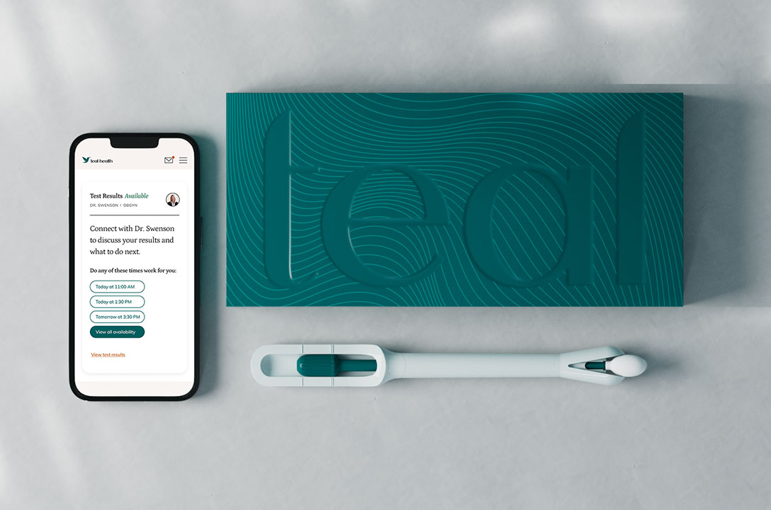 Flat lay of a phone showing a Teal Health 'Test Results Available' screen, a 'teal' box, and the wand.