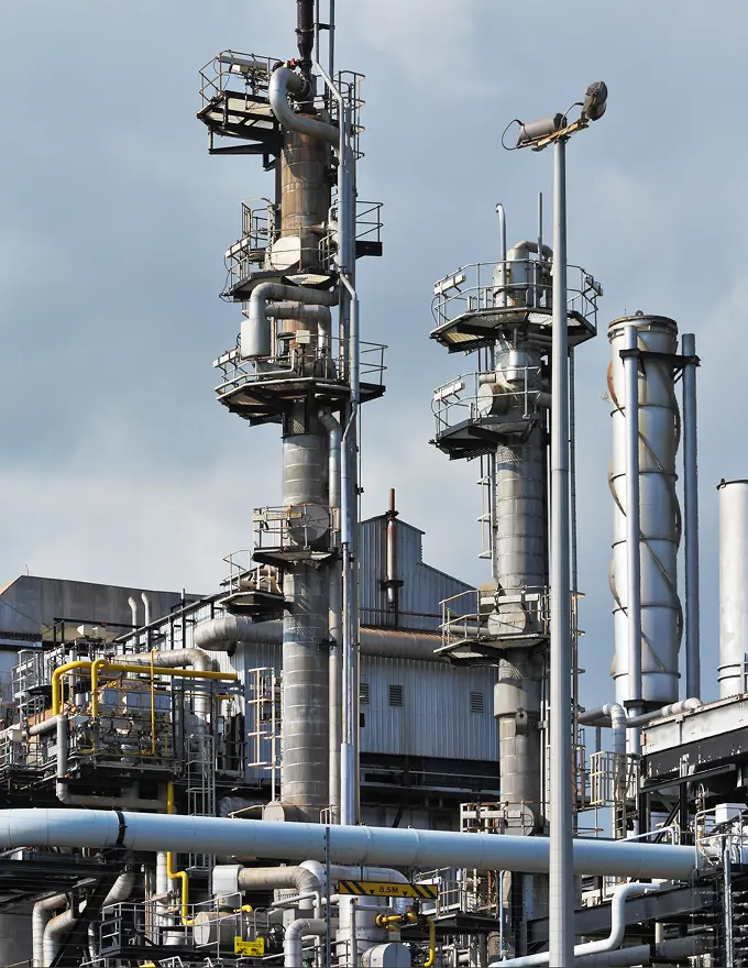 Refinery distillation towers and pipework at an oil and gas processing plant.