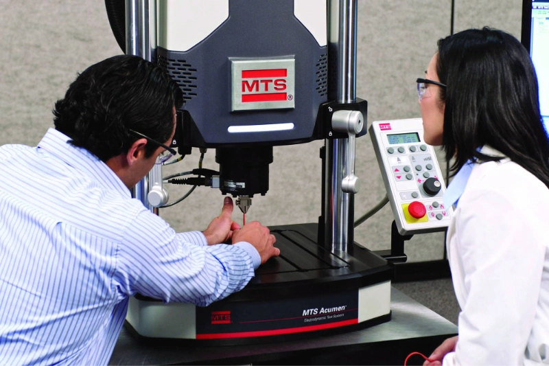 Engineers operating MTS testing equipment