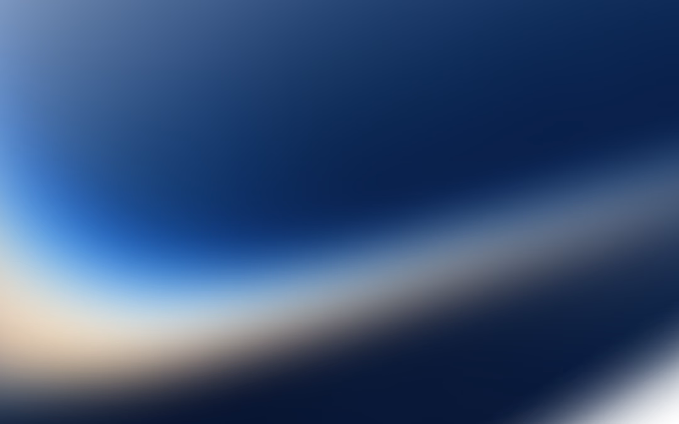 Abstract gradient background with smooth transitions from dark blue to light beige and white tones.