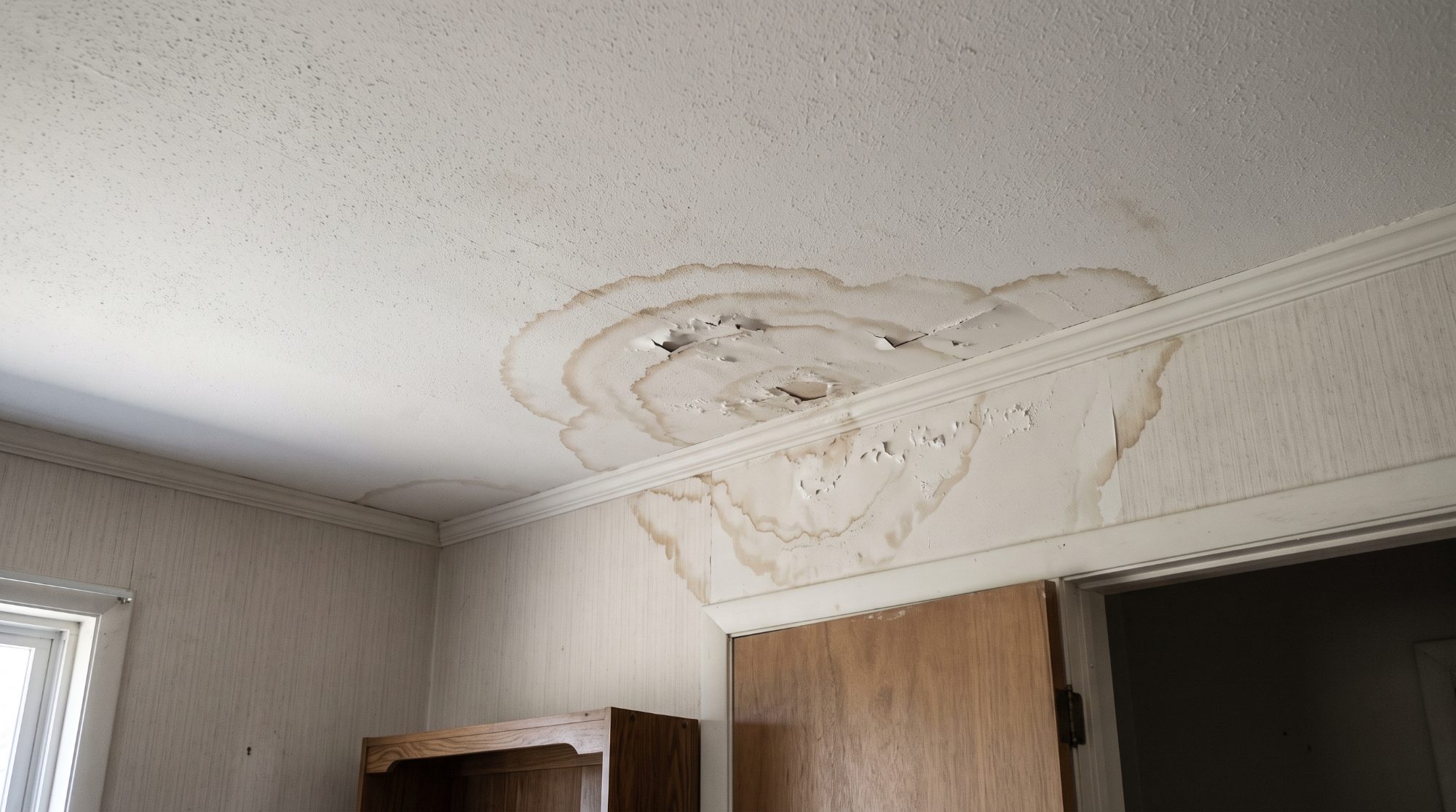 Water stains spreading from a slow ceiling leak