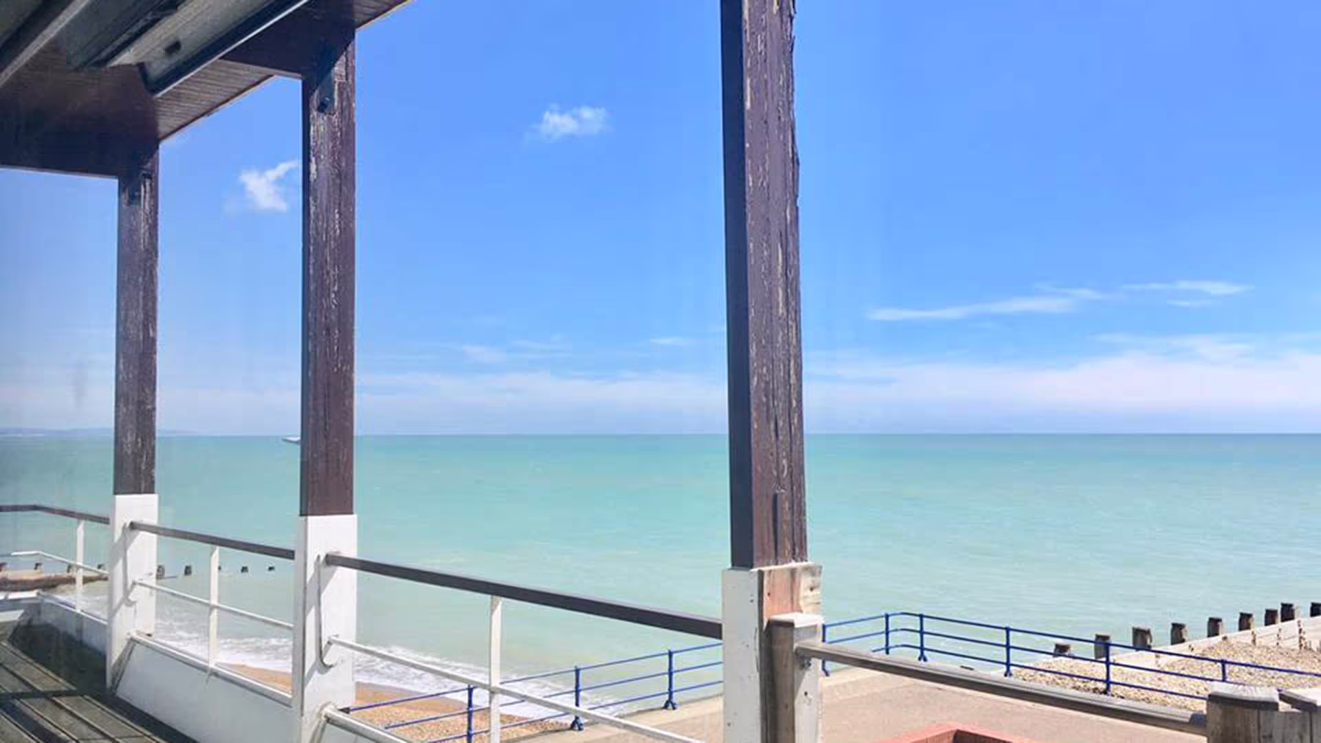 Eastbourne beach viwed through a veranda.