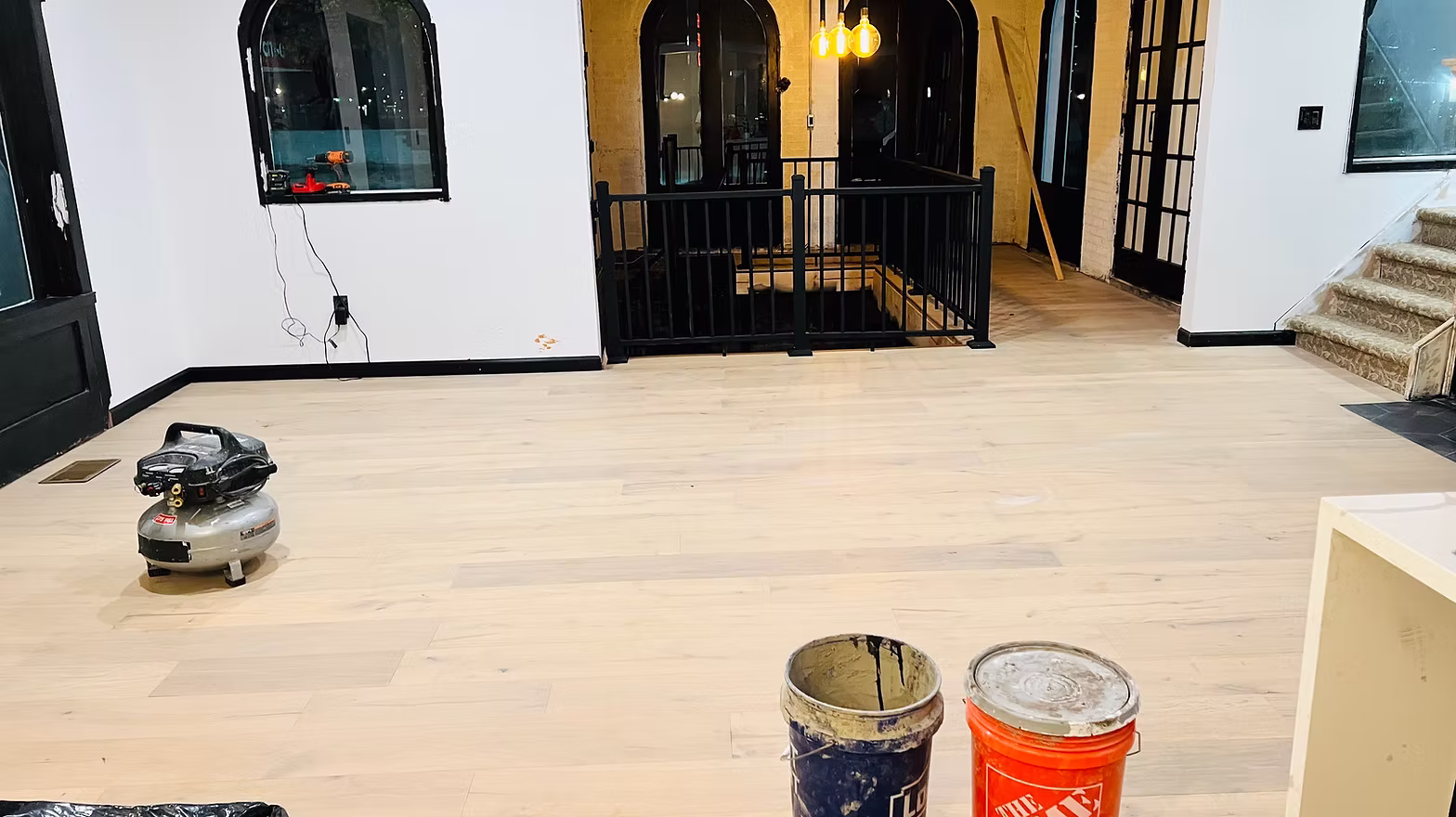 Newly installed hardwood floors and construction materials before a MAID Detroit post-construction cleanup