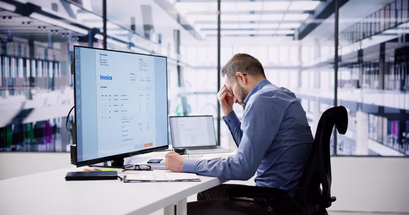 Executive reviewing technology spending and financial reports.