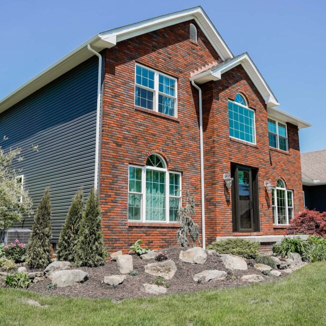 Brick two-story home with ProVia Endure windows and HeartTech siding