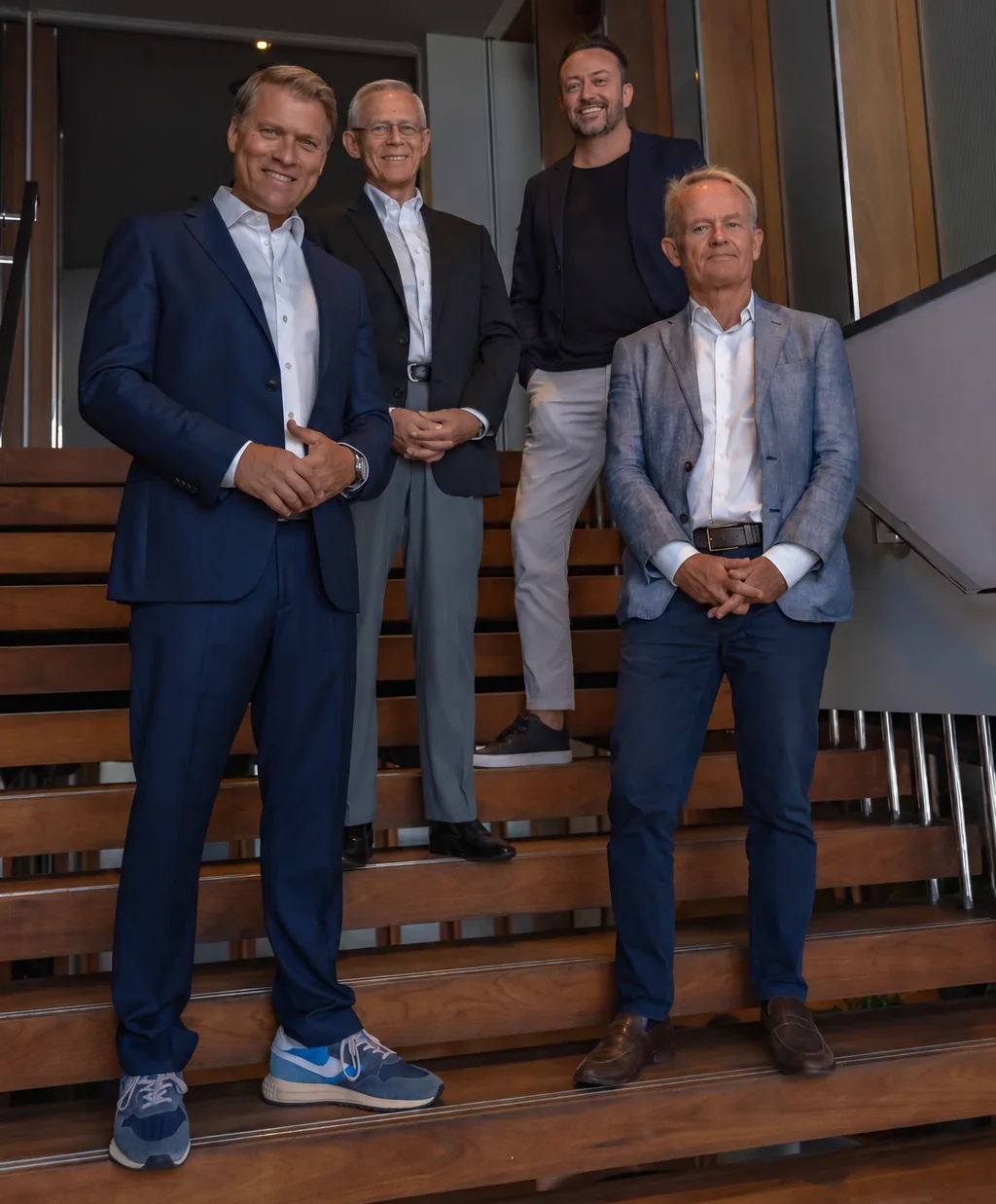 Four members of the team of The Principals Group on the stairs of the London office.