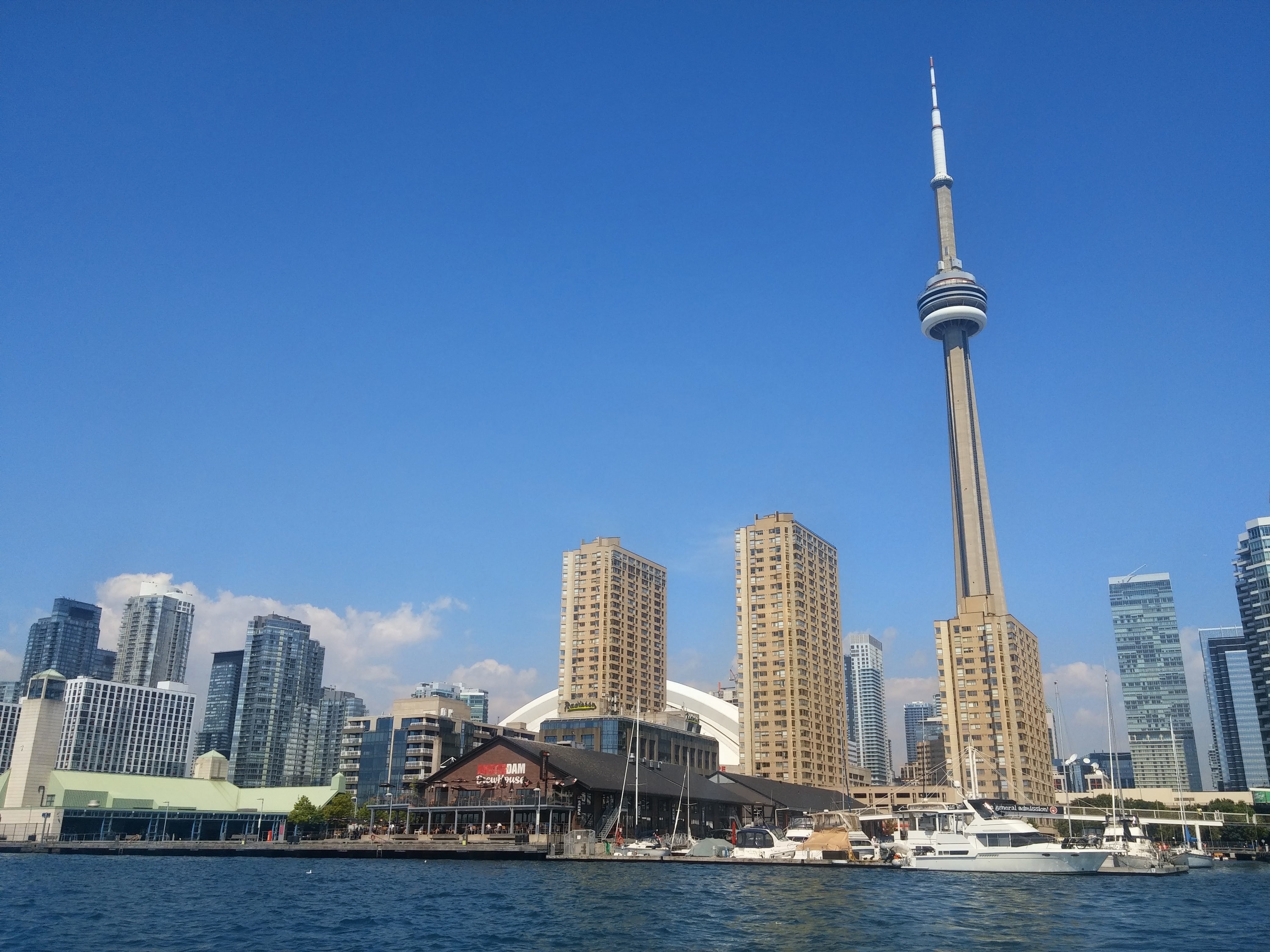 The CN Tower and waterfront condo towers seen from the water at Toronto's Harbourfront