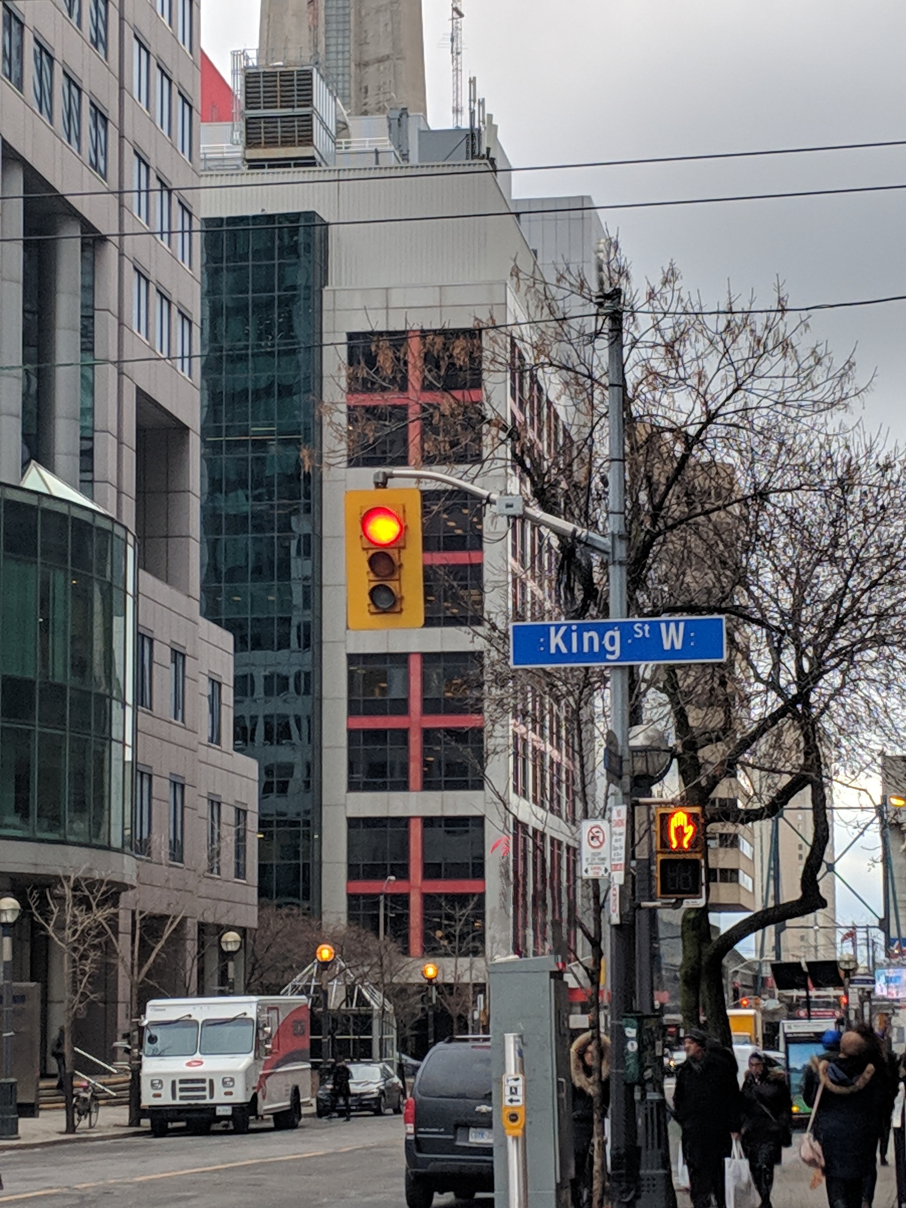 King Street West street sign and traffic light with office towers in downtown Toronto