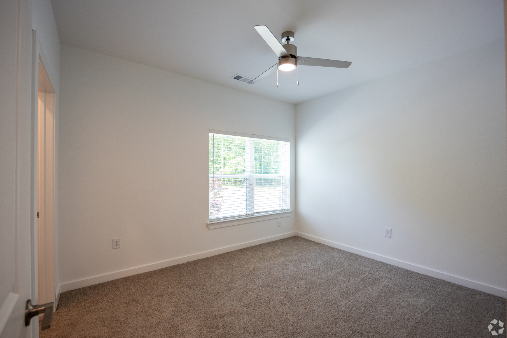 Bedroom with carpet, large window and ceiling fan