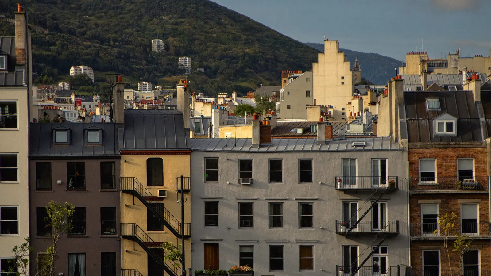 Montreal brick triplex rooftops with Mount Royal behind