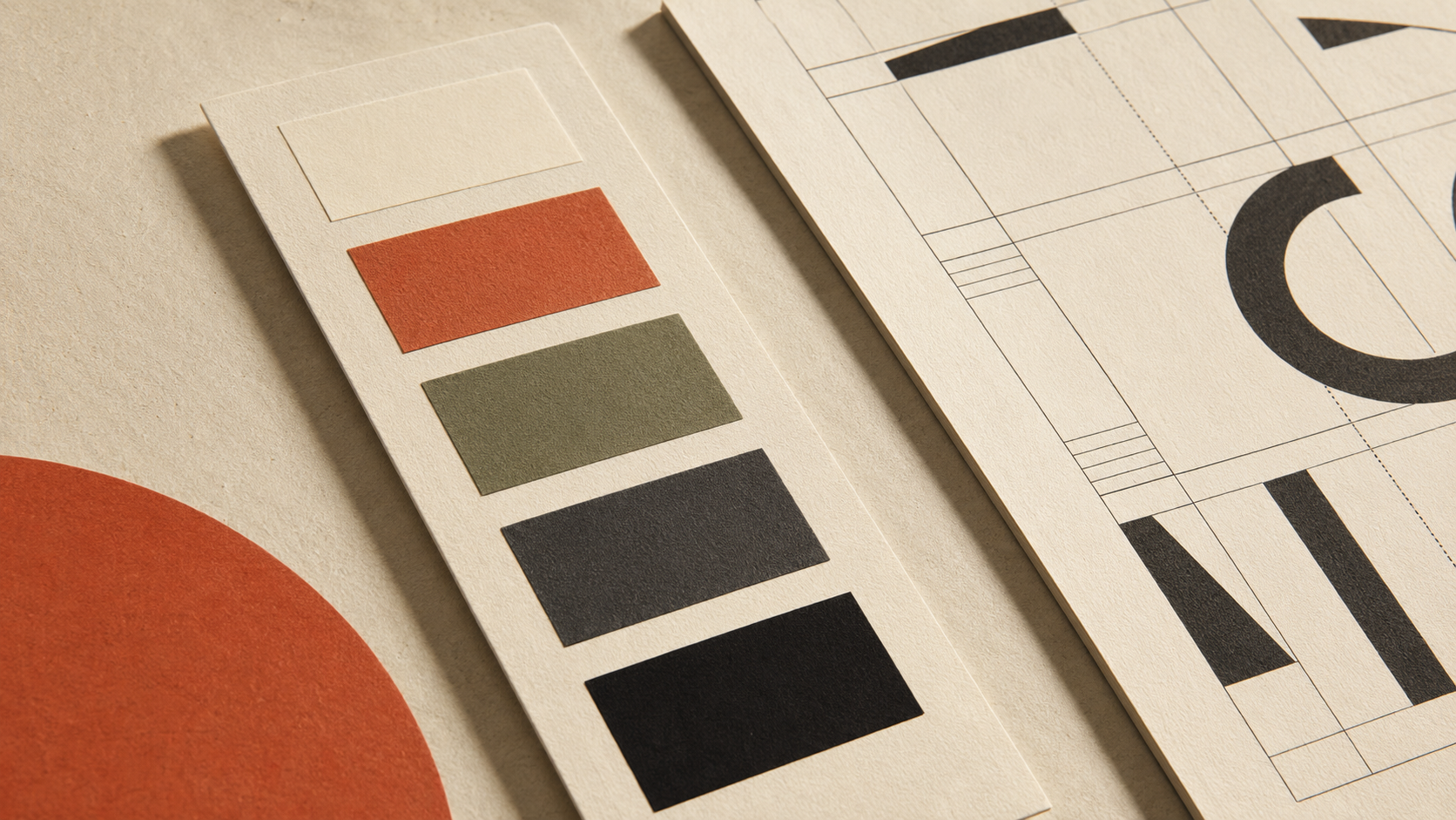 Palette card with four colour swatches in beige, terracotta, olive green, dark grey, and black on textured paper.