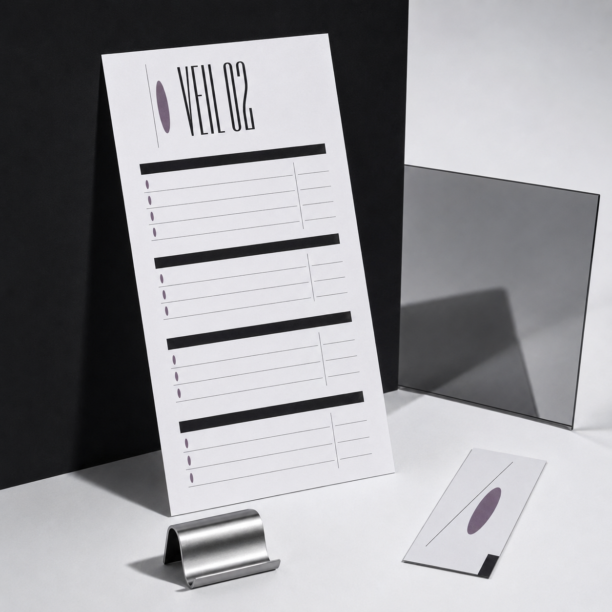 White paper with VEIL 02 title, lines, and dots next to a card and metal clip on white surface.