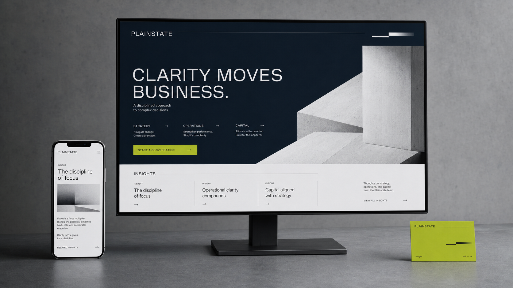A phone and monitor displaying a business website titled 'Clarity Moves Business' with a minimalist design.