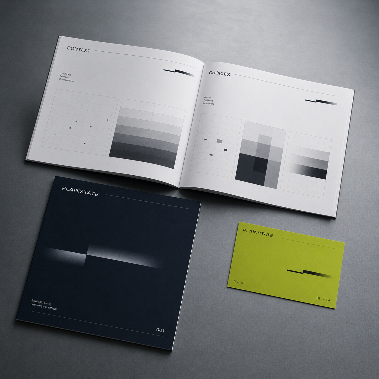 Open book and two booklets with grayscale bar charts and the word Plainstate on a gray surface.