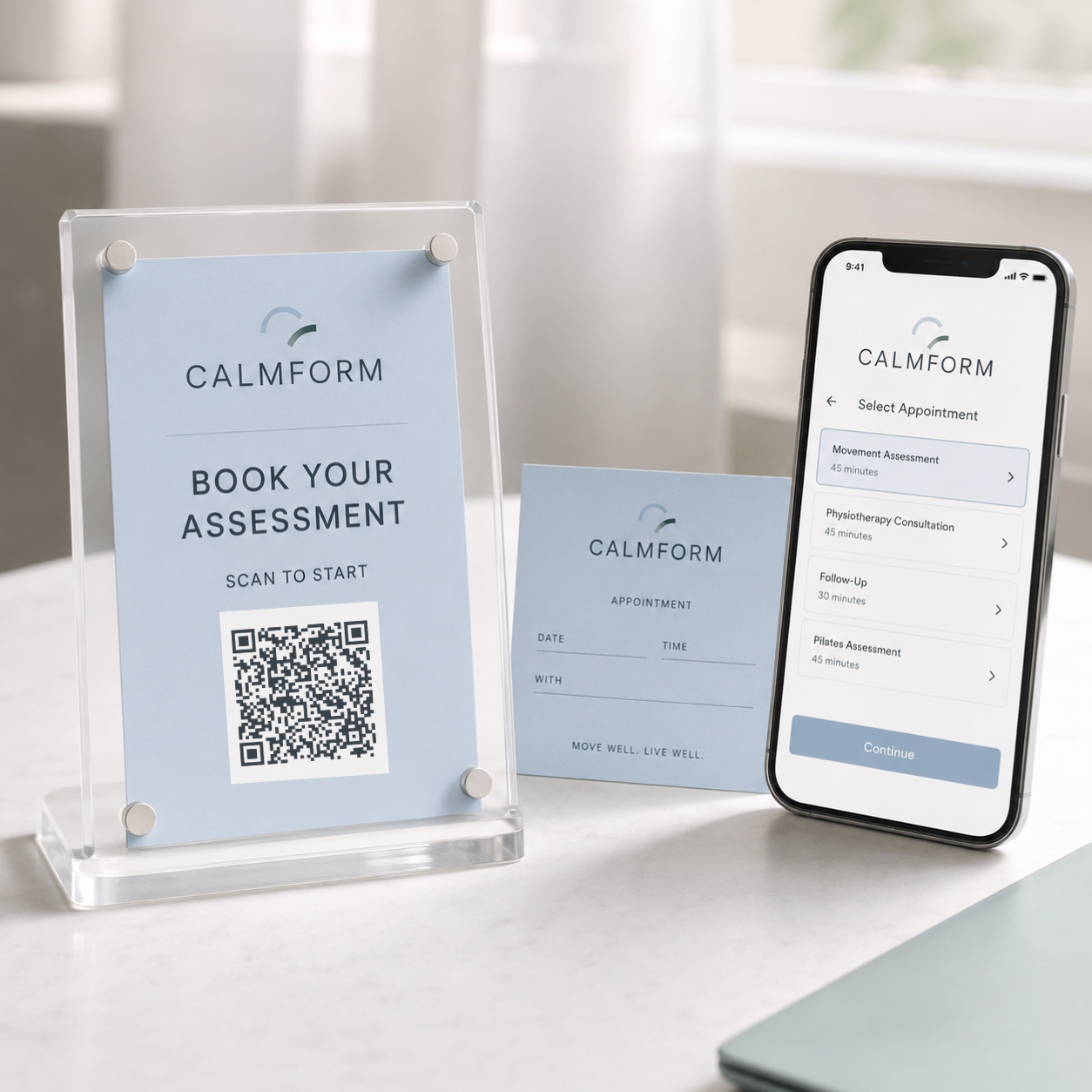 Desk display with Calmform booking sign, appointment card, and smartphone showing appointment options.