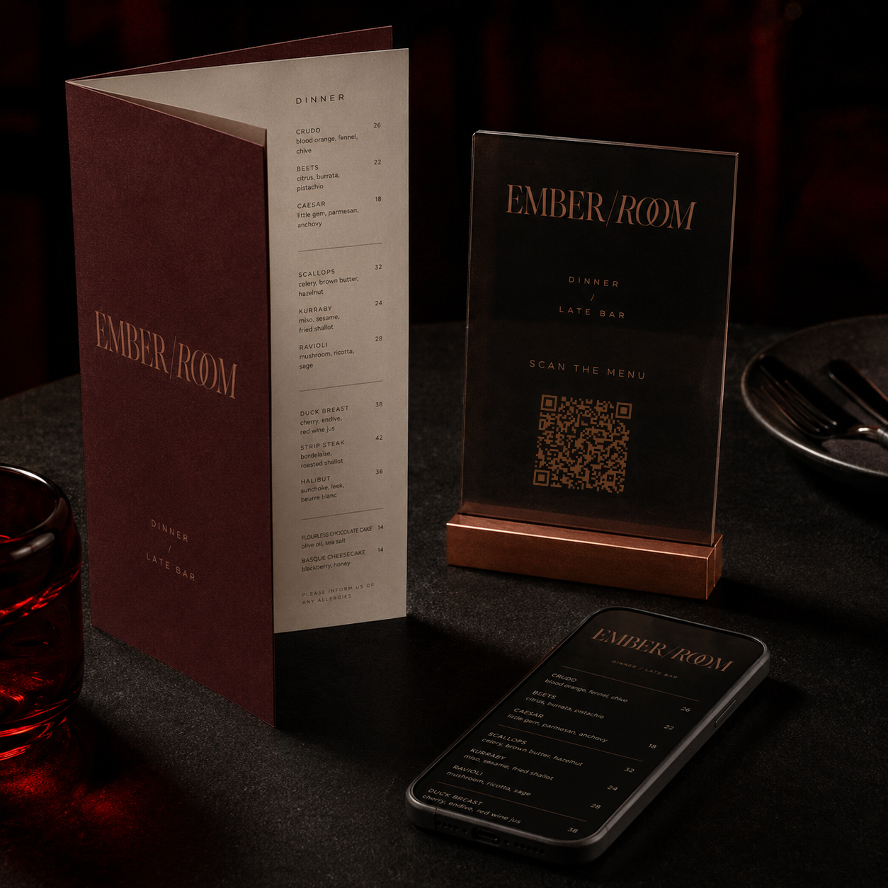 Table with Ember Room dinner menu, QR code sign, and phone showing the same menu in dark lighting.