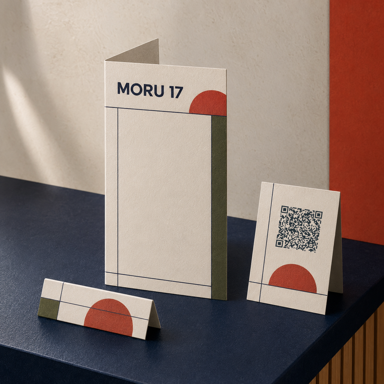 Minimalist beige paper set with red semicircle, green strip, and QR code on a dark blue surface.