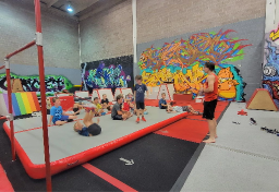 Parkour coach giving a lesson to a class of children.