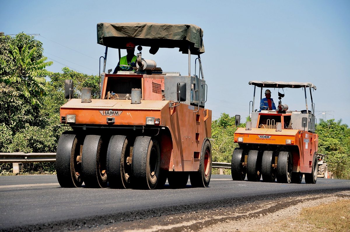 A Protasco maintenance crew resurfacing a federal road, with plant and traffic management in place.
