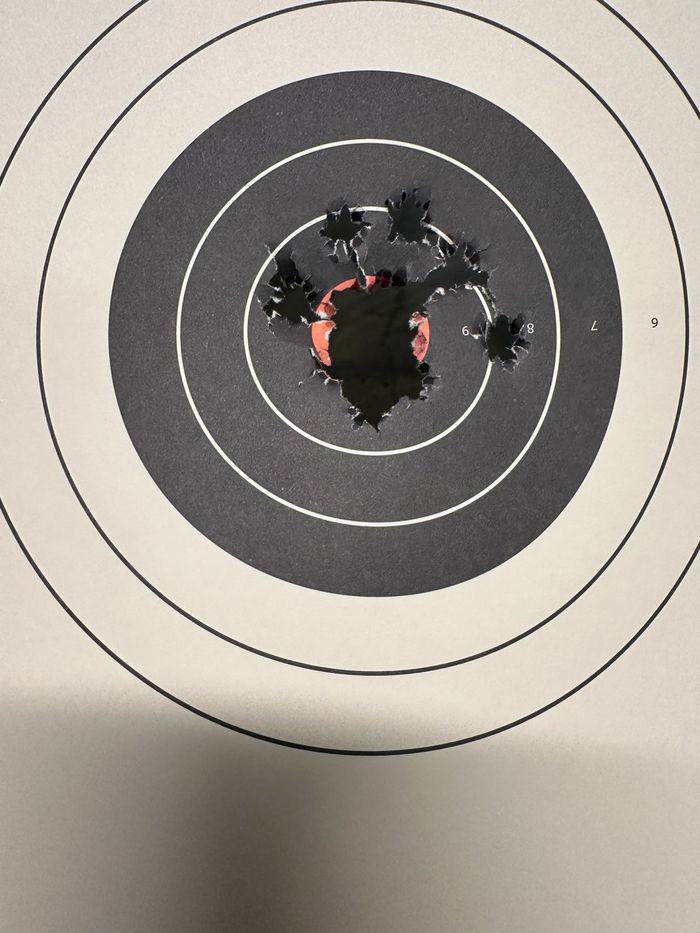 Tight shot group in the center of a bullseye target