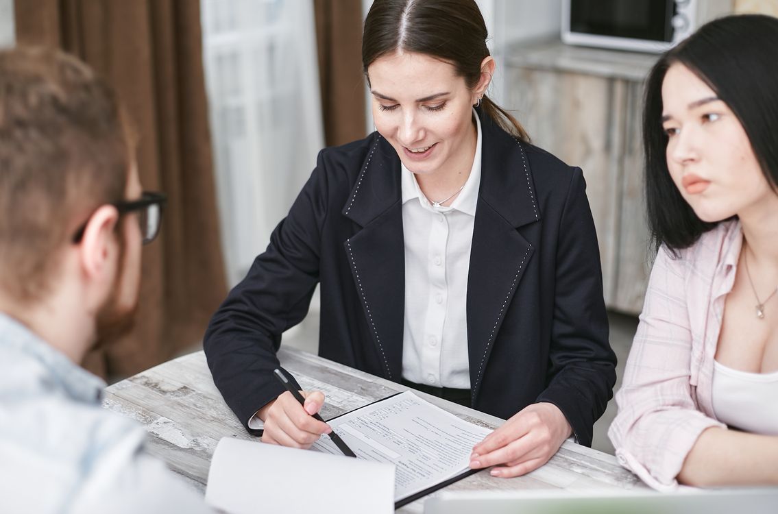 A team discussing documents and investment details during a business meeting