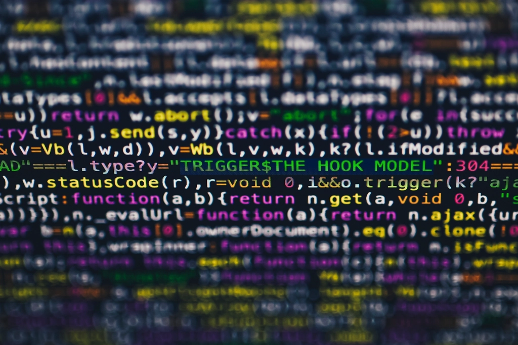Close-up of colourful JavaScript code on a dark editor screen, shallow depth of field.