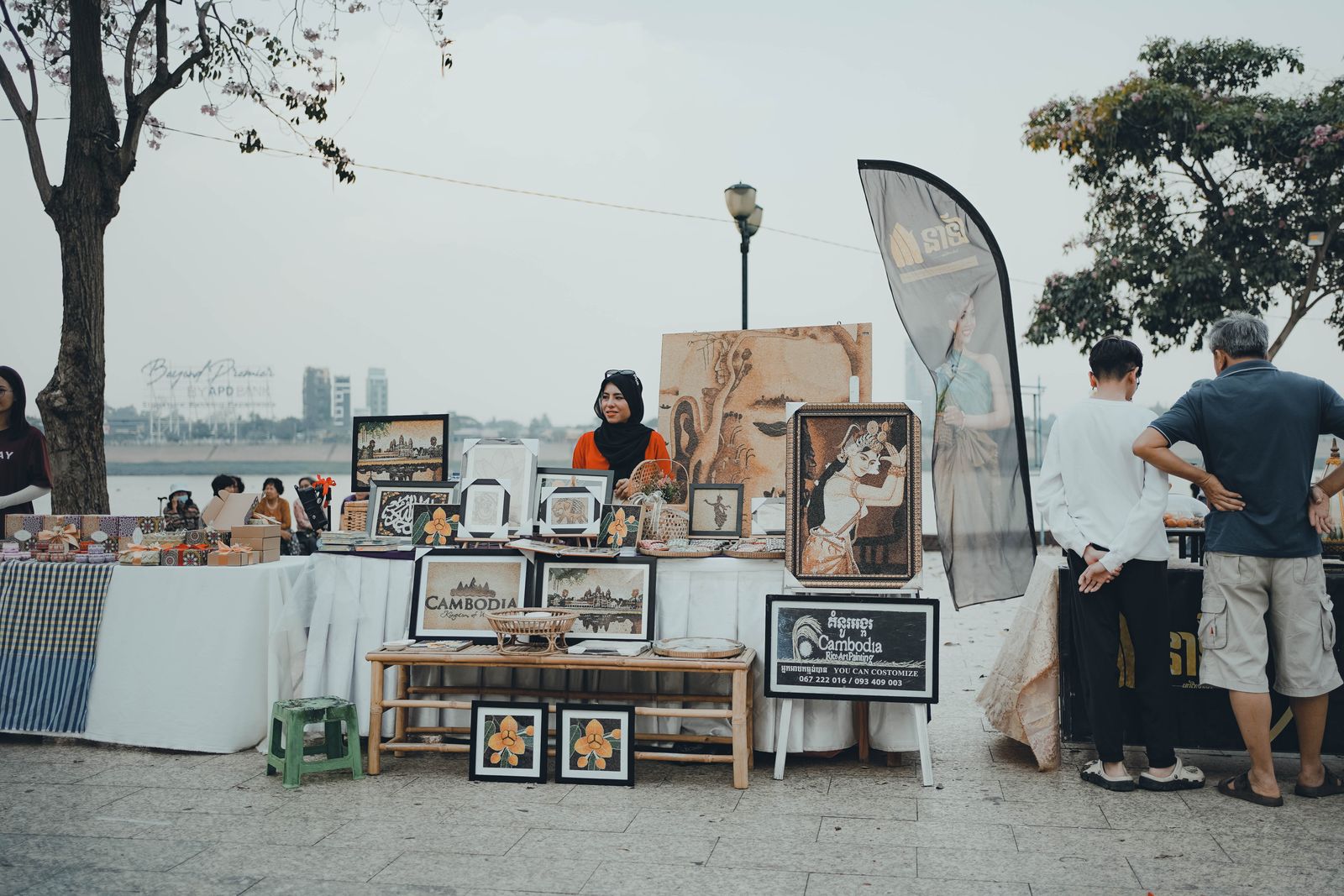 Local vendors selling Cambodian crafts at a riverside street market in Phnom Penh
