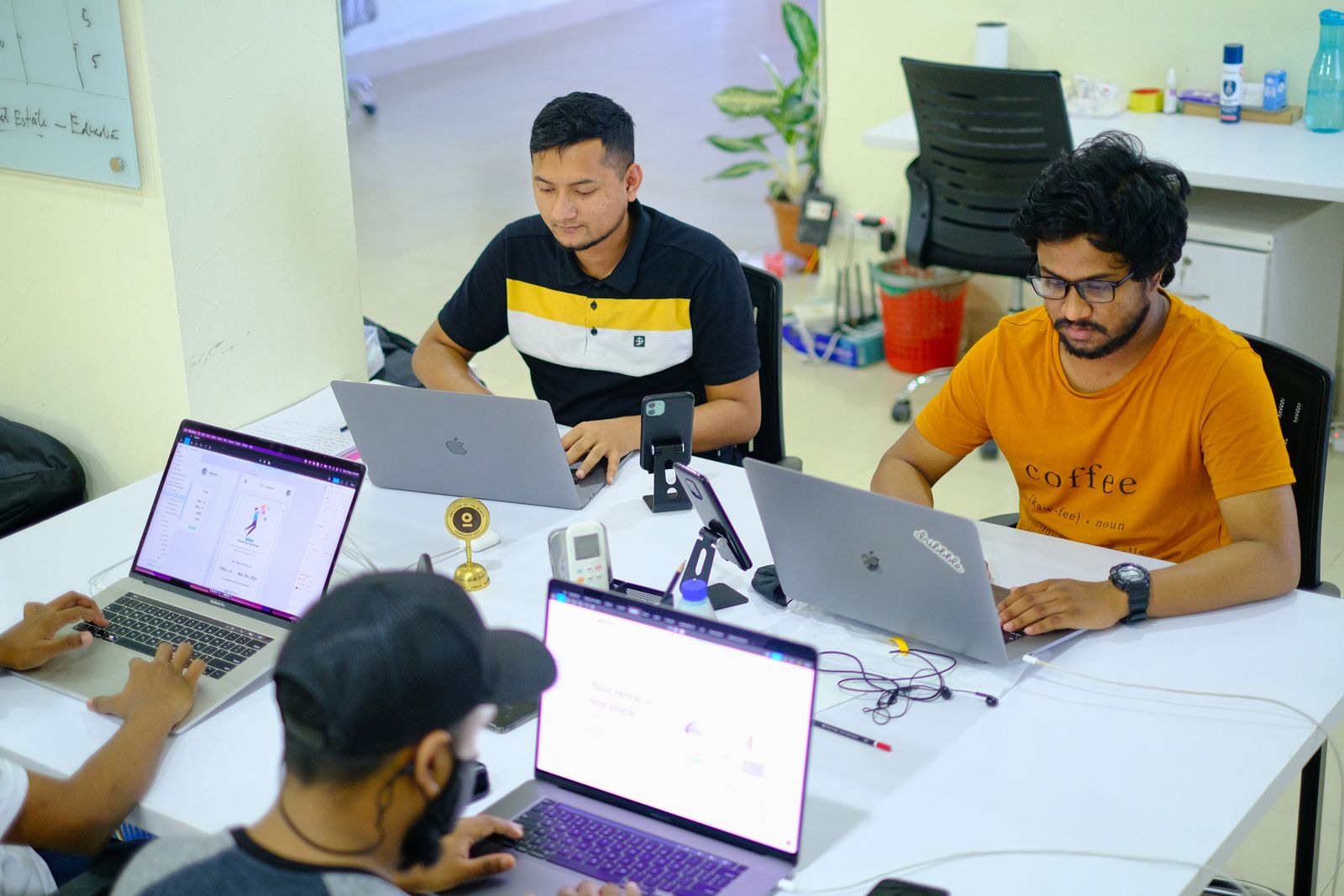 Agency team working together on laptops in a bright Phnom Penh office