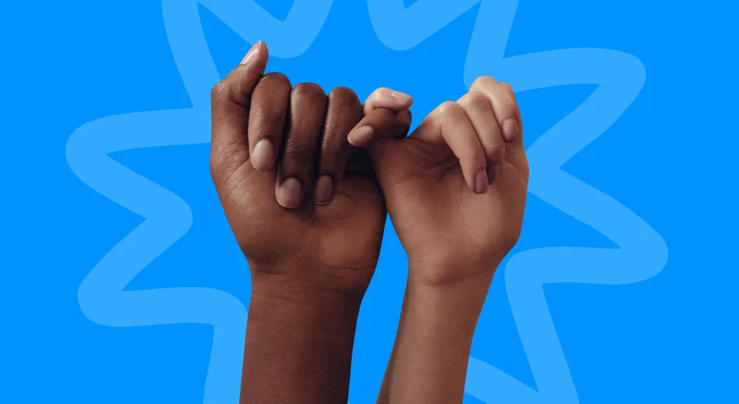 Two hands linking little fingers in a pinky promise against a blue background.