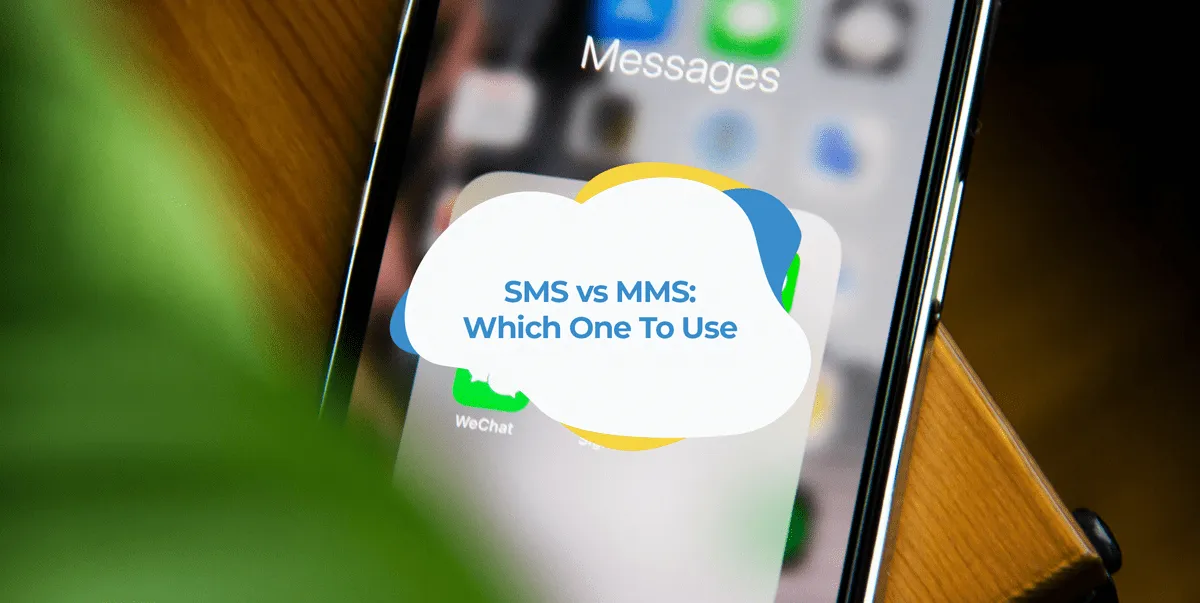 Phone screen showing the Messages app icon on a wooden desk.