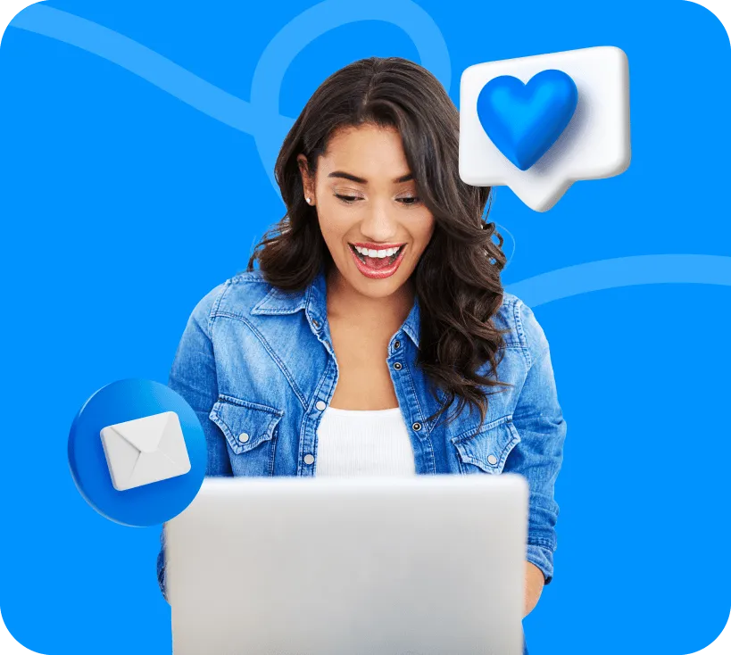 Smiling woman at a laptop with envelope and heart icons floating beside her.