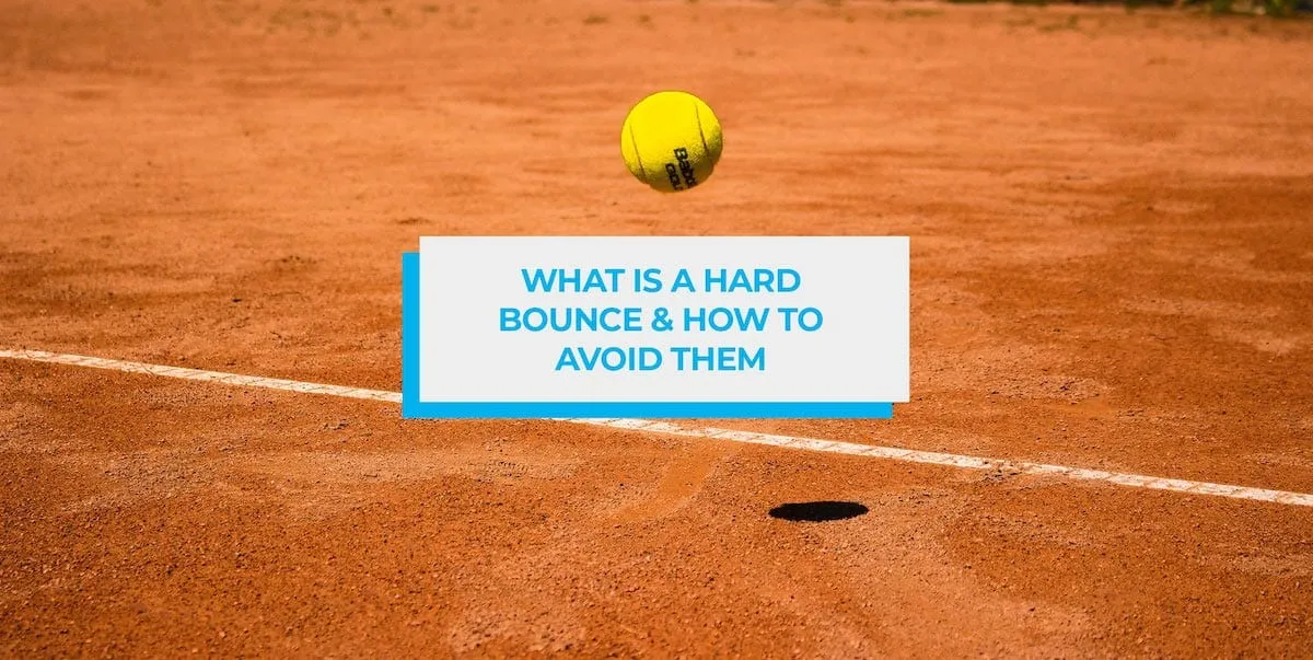 Tennis ball bouncing on a clay court beside the baseline.