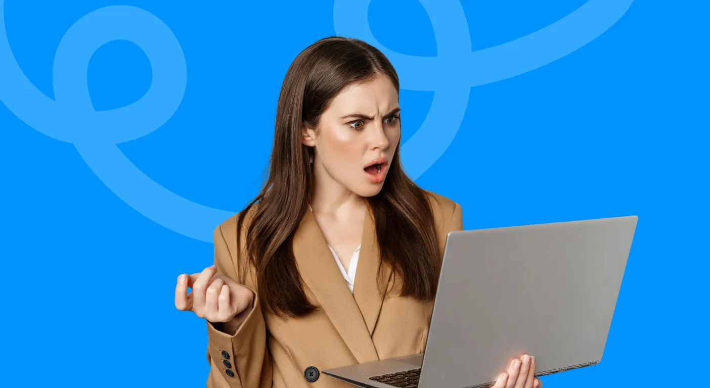 Frustrated woman frowning at the laptop she is holding.