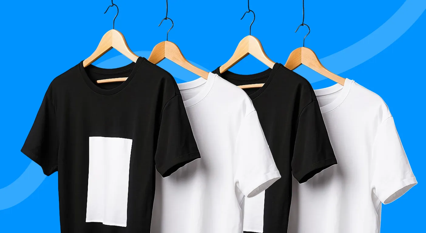 Four plain black and white t-shirts hanging on wooden hangers.