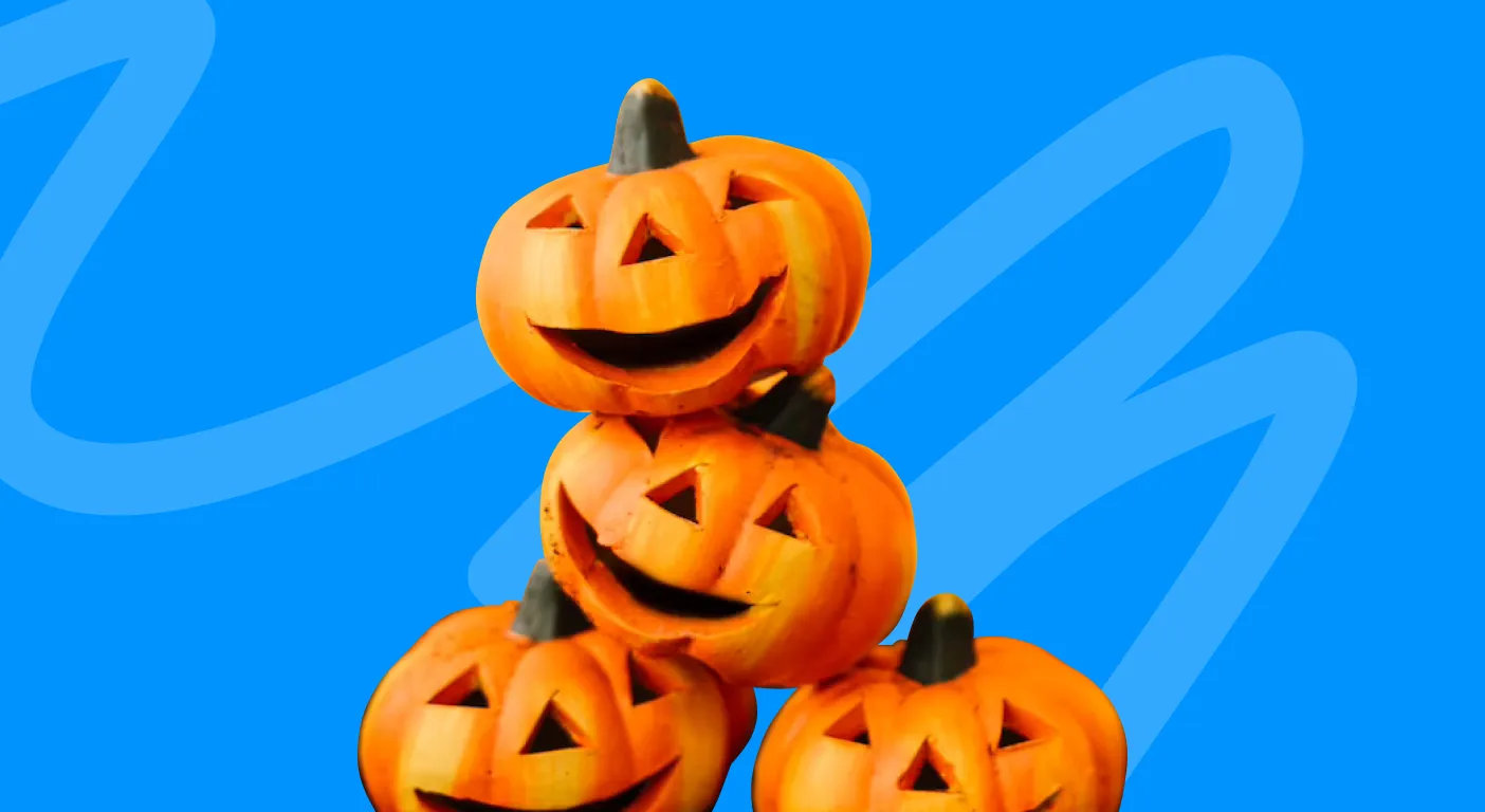 Stack of carved jack-o'-lantern pumpkins on a blue background.