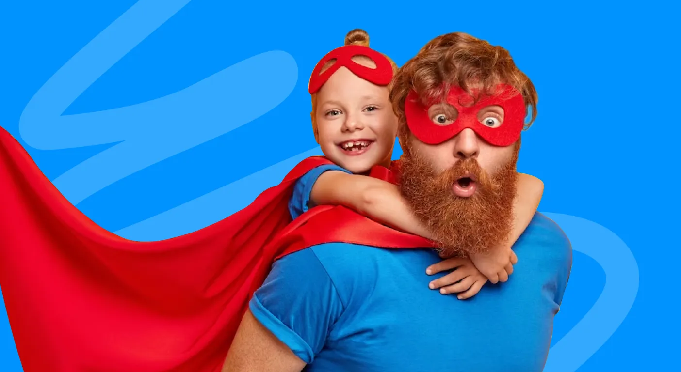 Father and child in matching superhero masks and red capes.