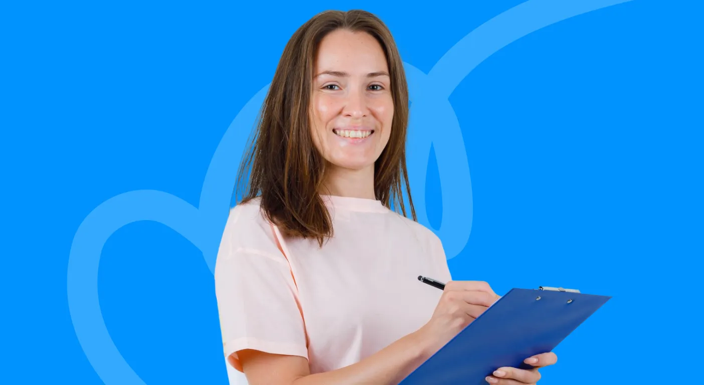 Smiling woman ticking items off a clipboard.
