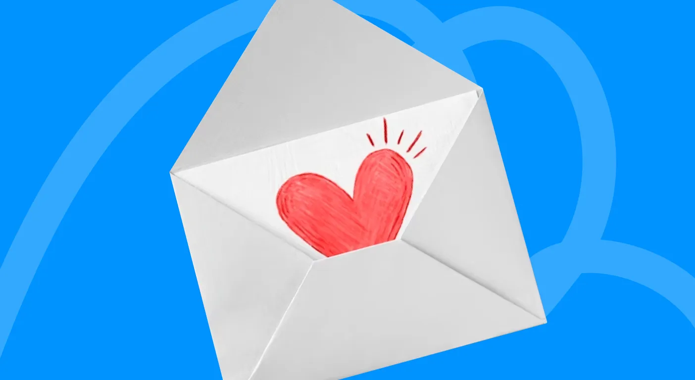 Open white envelope with a hand-drawn red heart inside it.