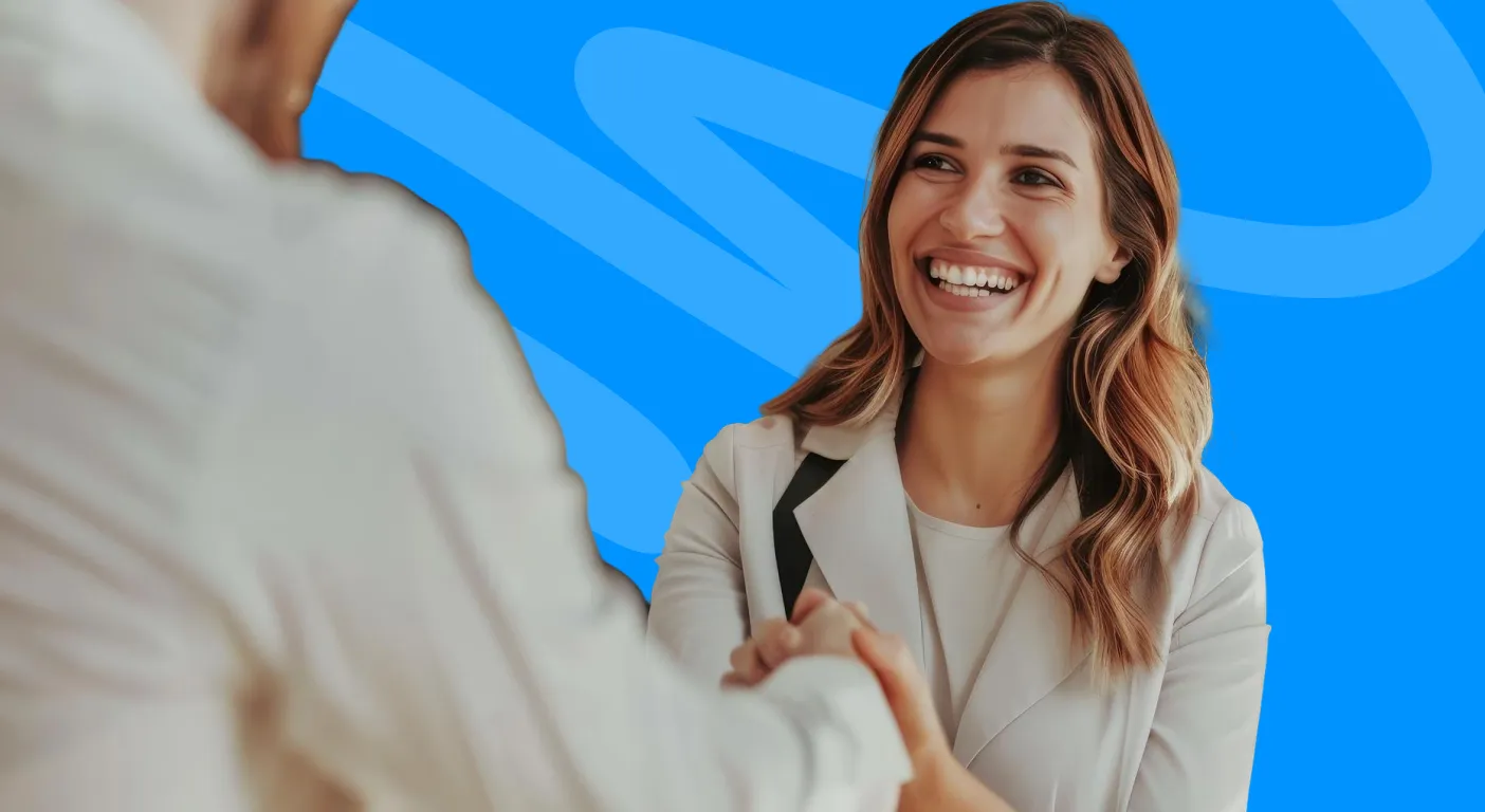 Smiling woman shaking hands with a client.
