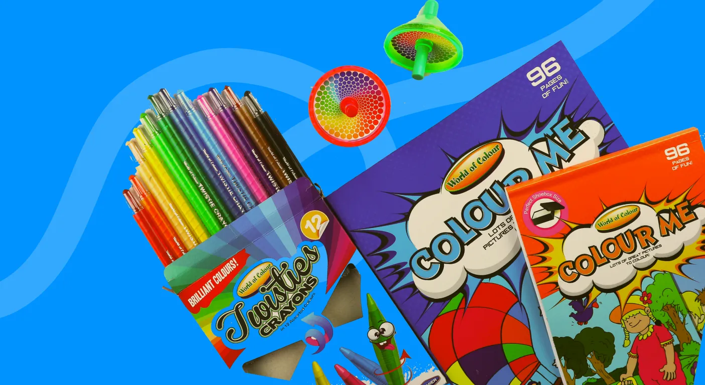 Pot of coloured pencils beside colouring books and a spinning top.