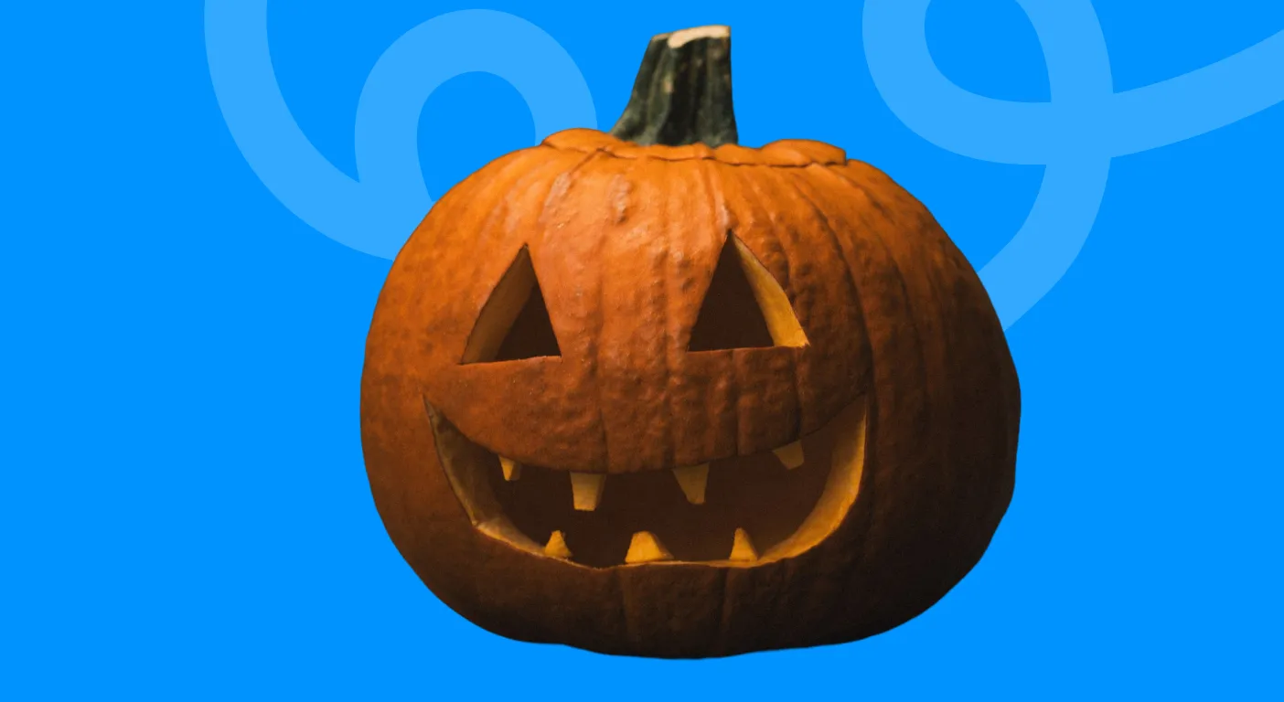 Carved jack-o'-lantern grinning against a bright blue background, illustrating Halloween email subject lines.