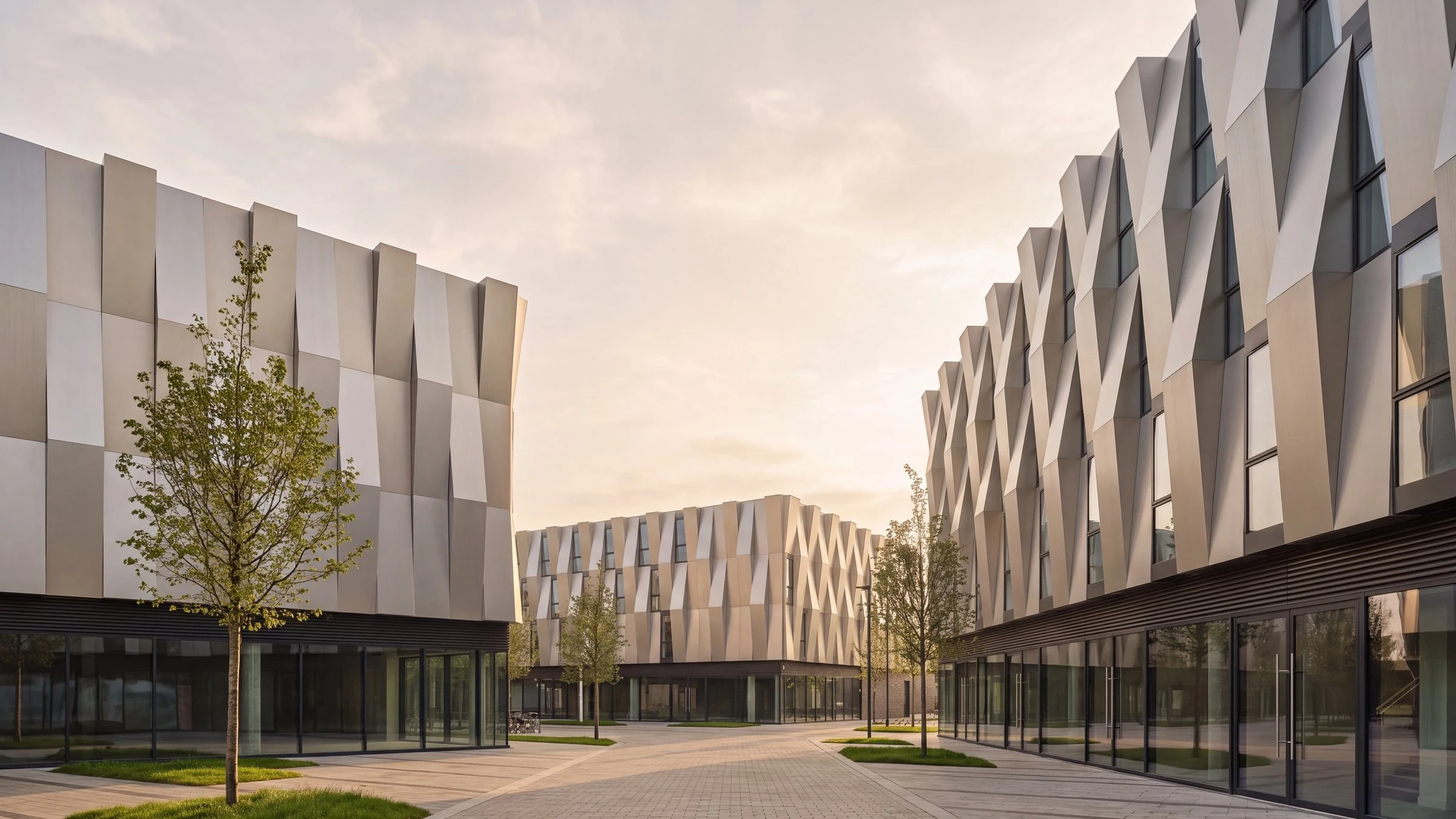 Computer-generated image of the same scheme seen from the public-realm street between the two buildings, with glazed commercial ground floors and a block-paved shared surface.