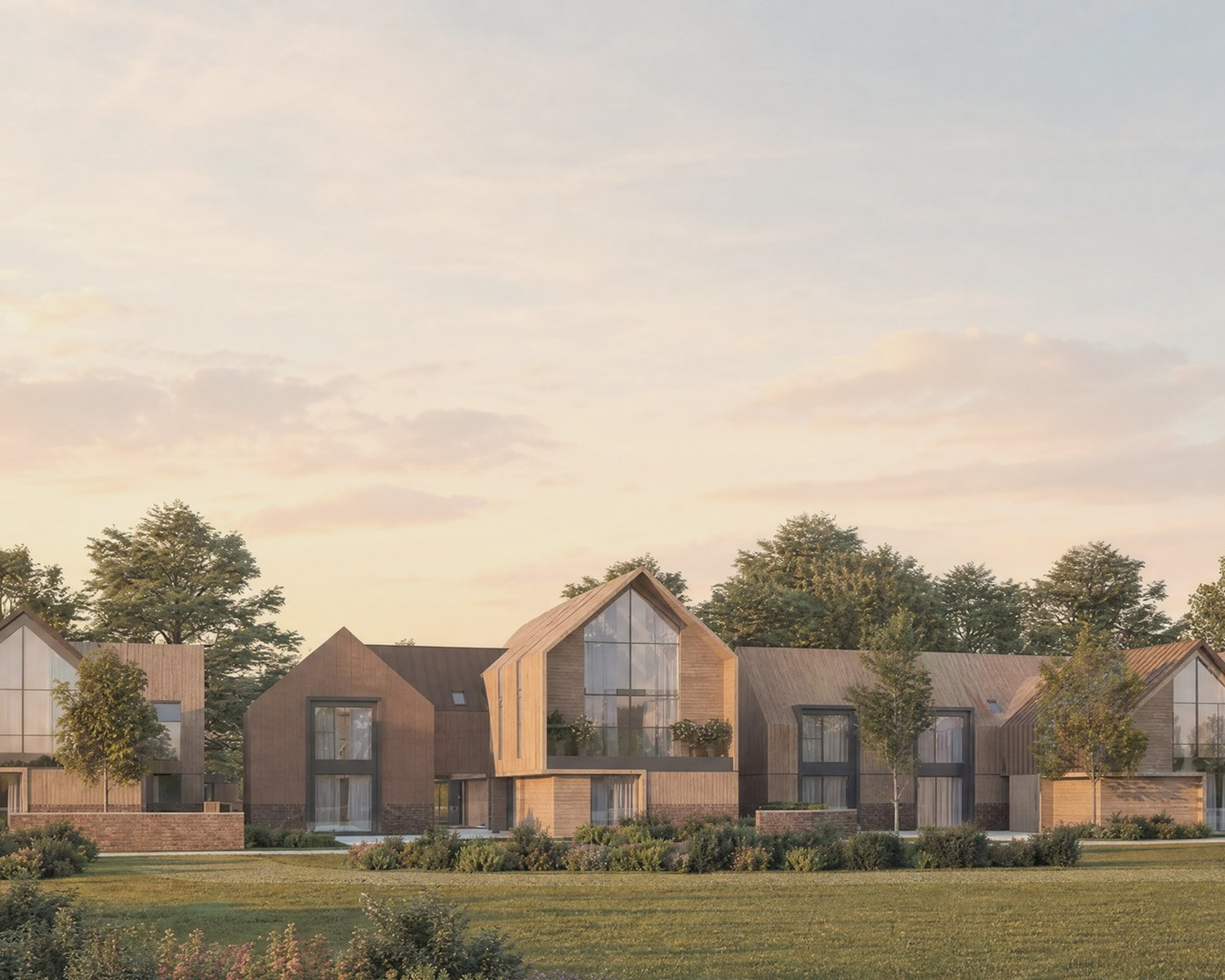 Visualisation of the consented scheme at Inwoods Park, Rugby: gabled houses in brick and timber with standing seam zinc roofs, seen across the meadow in evening light. The homes are under construction.