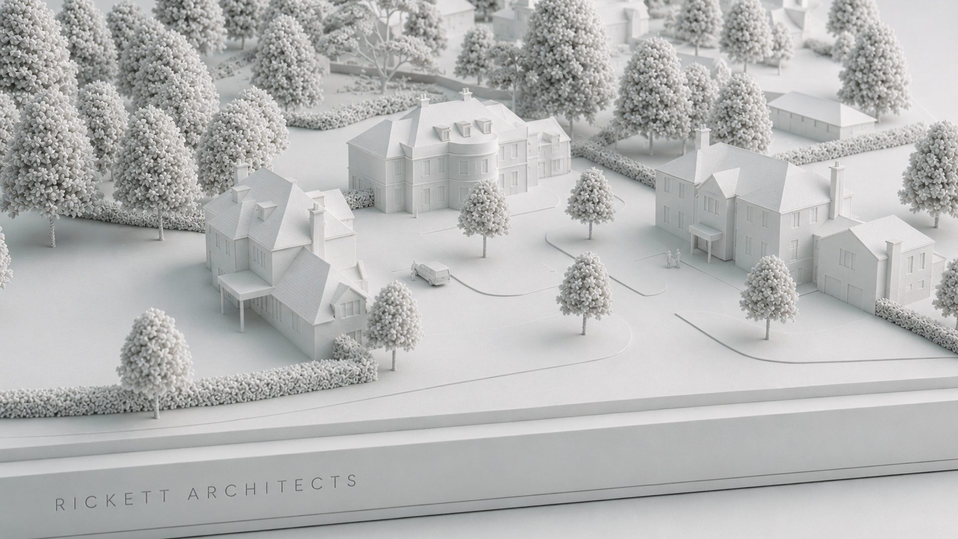 A white architectural model of the Ide Hill development near Sevenoaks: a principal house and classical detached country houses set in wooded, gently falling parkland, on a Rickett Architects base