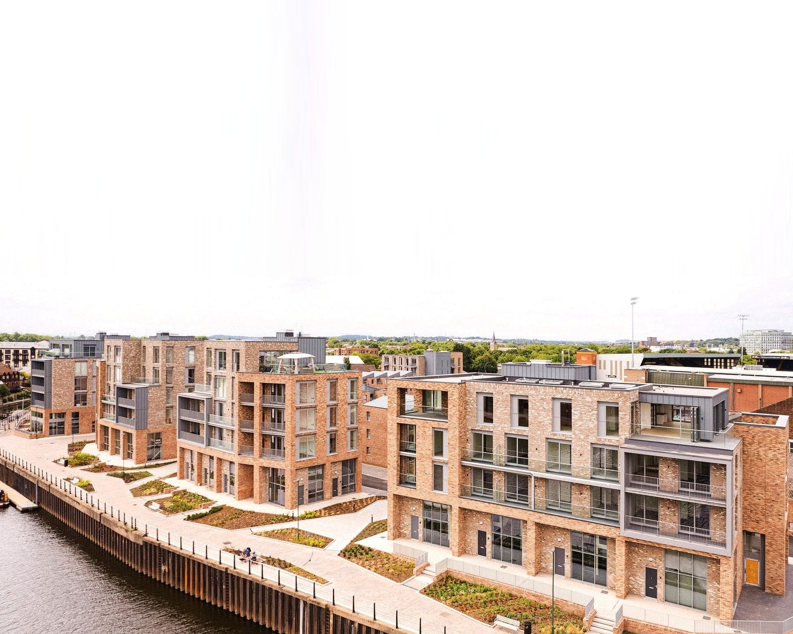 Photograph of the completed riverside homes at Muller Yard, Nottingham, on the bank of the River Trent.