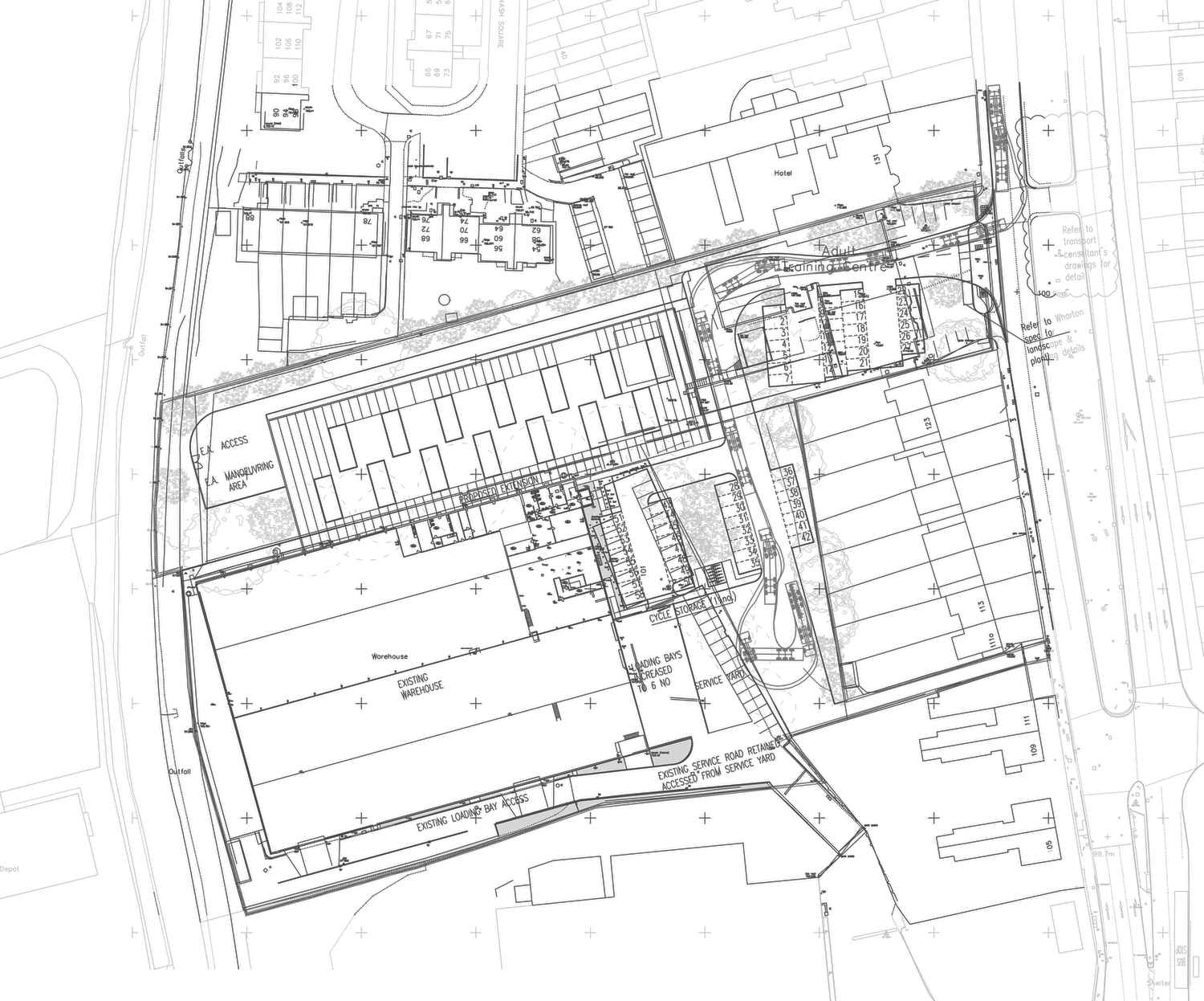 Site plan of the Aldridge Road scheme: the long proposed extension set along the northern boundary with its structural grid shown, the existing warehouse labelled below it, service yards between the two, ranks of parking bays to the east, a new access curving out to Aldridge Road, a manoeuvring area reserved for the Environment Agency on the river side, and surrounding houses and industrial units drawn faintly beyond the boundary