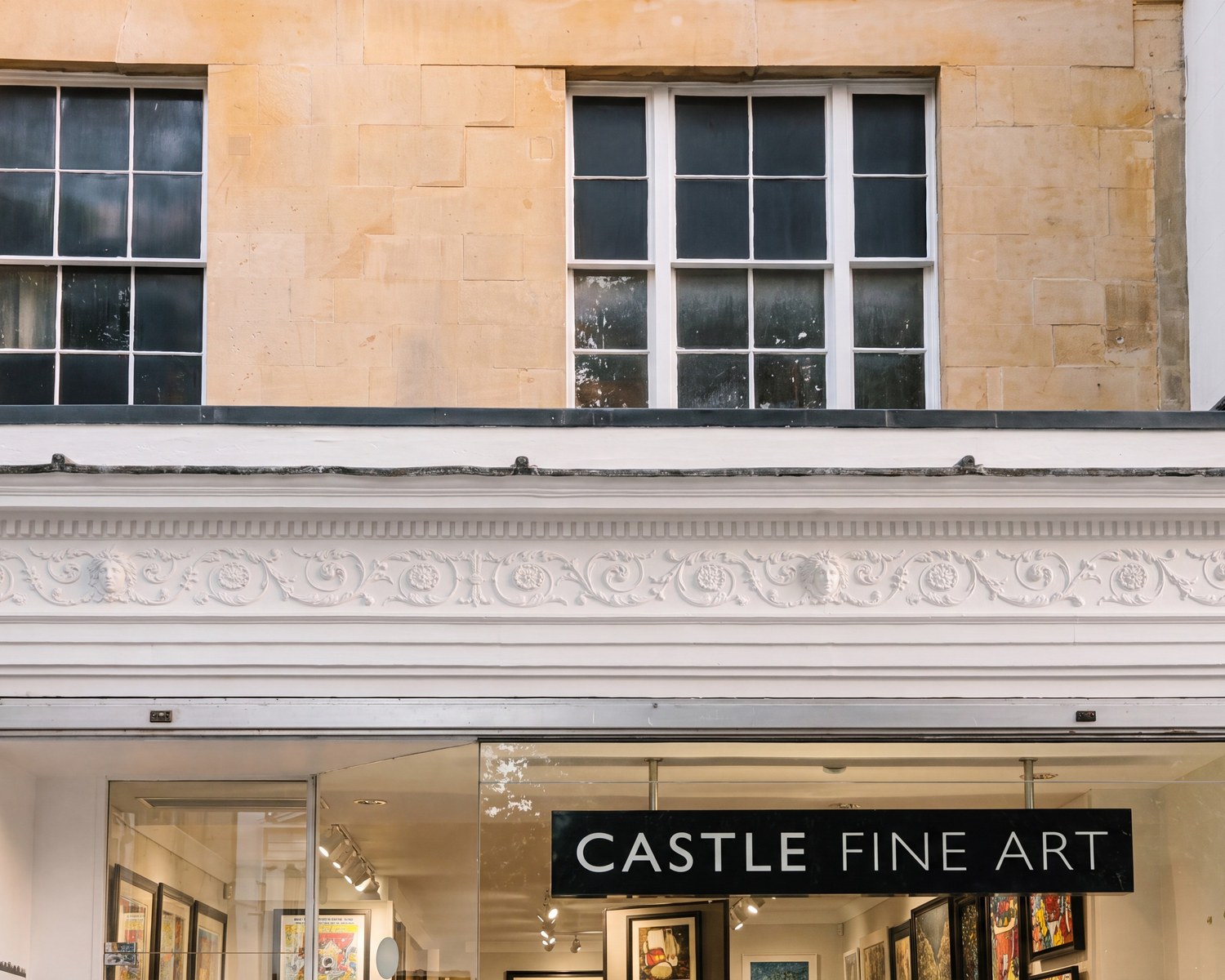 Photograph of 82A The Promenade, Cheltenham: the Regency stone facade of Castle Fine Art gallery, with sash windows above and a glazed shopfront below.
