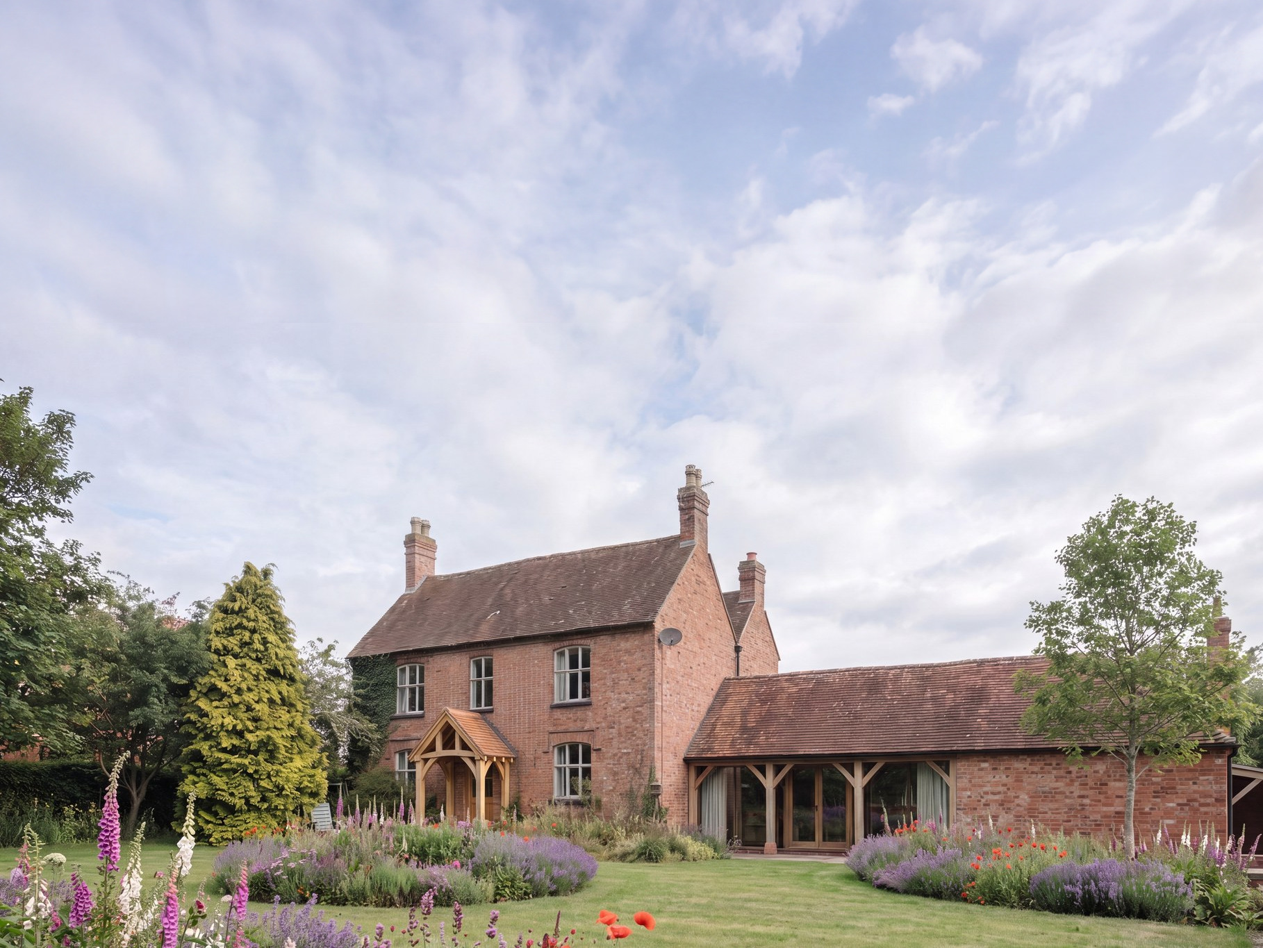 Visualisation of the consented scheme at Cannings Farm, Norton Lindsey: the retained brick farmhouse with its new oak porch, beside the converted farm building behind an oak loggia.
