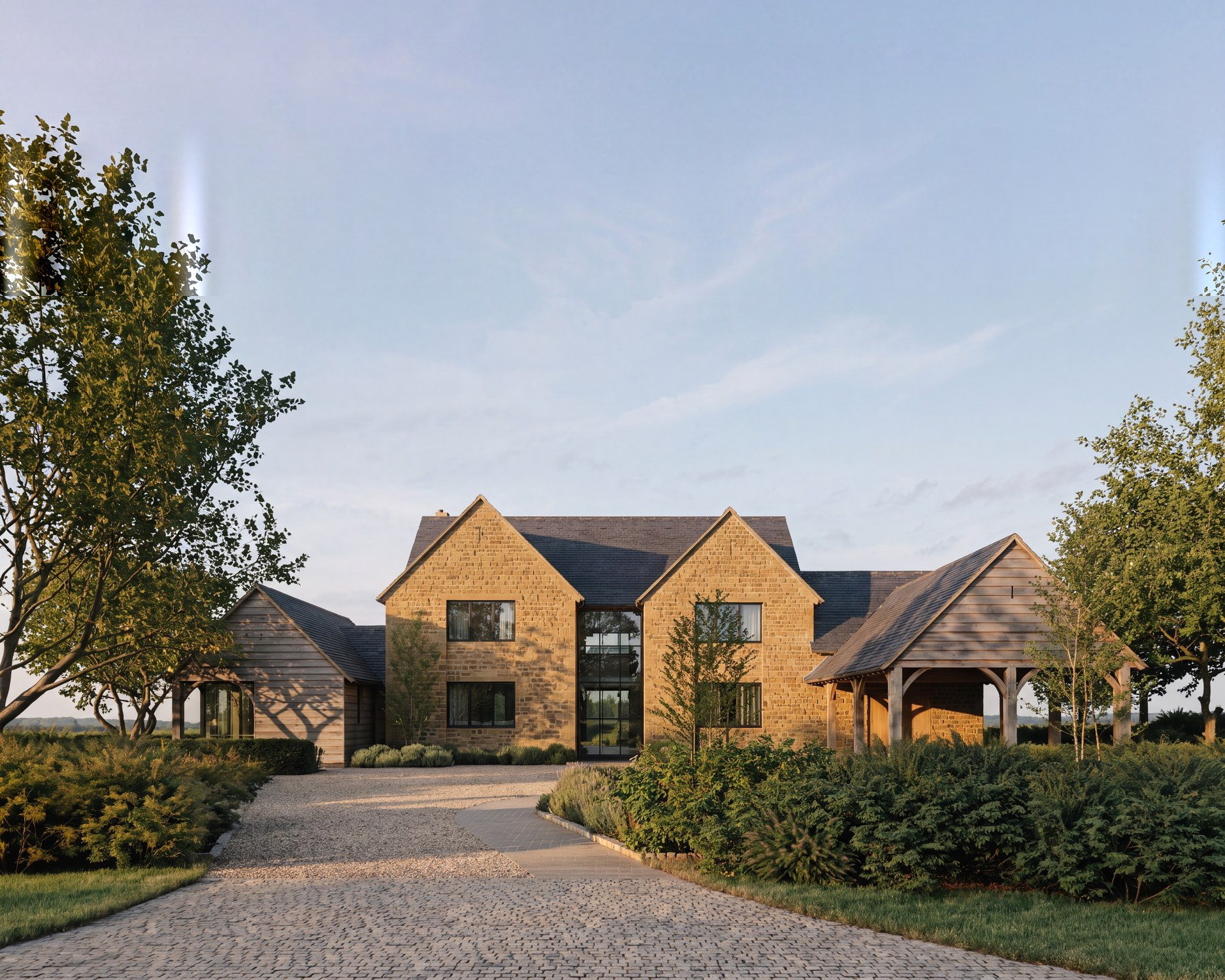 Visualisation of the consented design at Hollow Meadow Farmhouse, Priors Hardwick: a coursed natural ironstone house with paired gables, a recessed full-height glazed centre and an open oak car port.