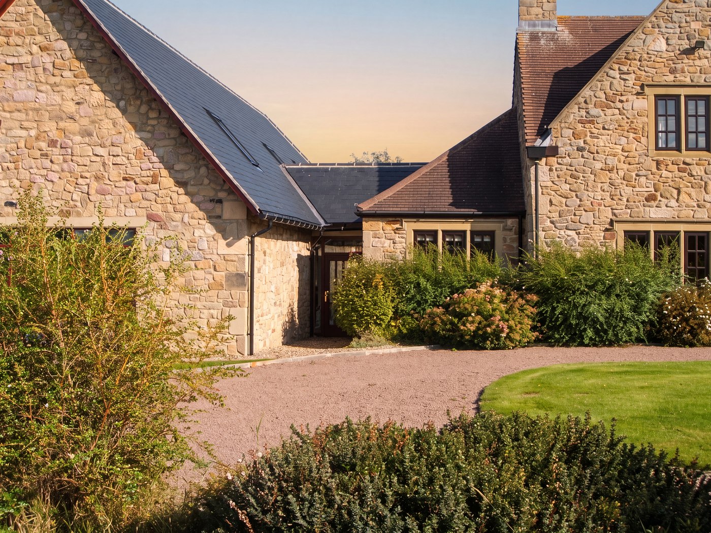 Visualisation of the completed courtyard: the new stone wing meeting the house through a glazed link